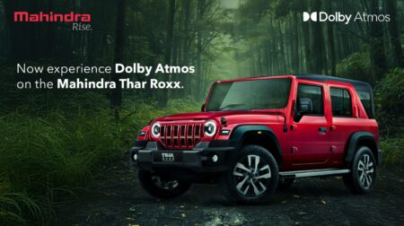 Mahindra and Dolby introduce first SUV with four-channel immersive audio Mahindra Mahindra Thar ROXX AX7L variant in a green forest.