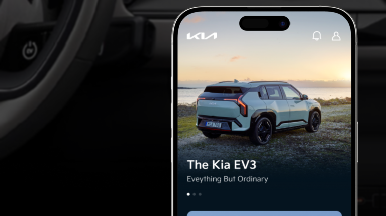The Kia App on a smartphone, shown against a backdrop of the interior dashboard of a Kia automobile.