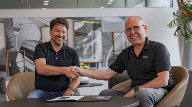 Dr Matthias Traub (Vector), left, and John Wall (QNX), right, during the signing of the memorandum of understanding.
