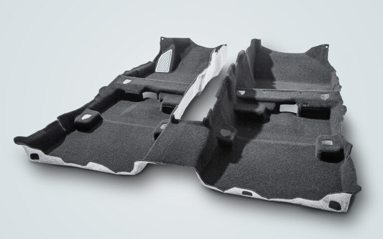 Autoneum develops adhesive-free carpet The Autoneum adhesive-free carpet N-Join1 shown on a cutout section of a vehicle interior.