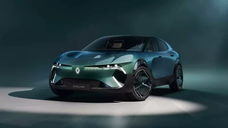 An image of a green car against a darker background with a subtle spotlight shining on the vehicle from above
