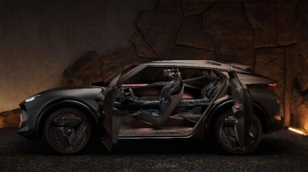 INTERVIEW: Combining performance and sustainability with Bcomp’s flax fiber in Cupra’s Tindaya The Tindaya Showcar shown in profile, with the left-hand side doors open to reveal the interiors, against an atmospheric black and dark-brown background