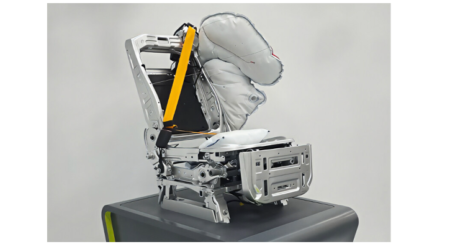 An illustration of the new seat safety solutions from Adient and Autoliv, featuring a grey metallic chair, a yellow seatbelt and grey-white cushioning