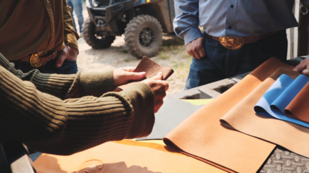 Data-driven traceability comes to automotive leather with Pangea’s new collaboration Woman holds a piece of automotive leather on a farm