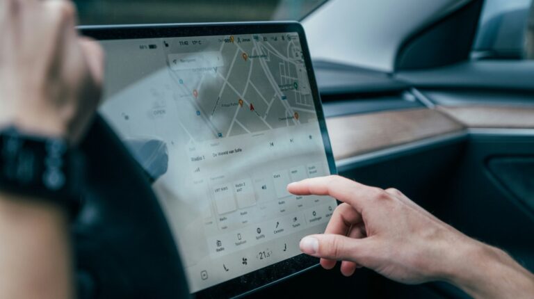 Cirrus Logic unveils new family of haptic drivers A person in a vehicle reaching for the infotainment system