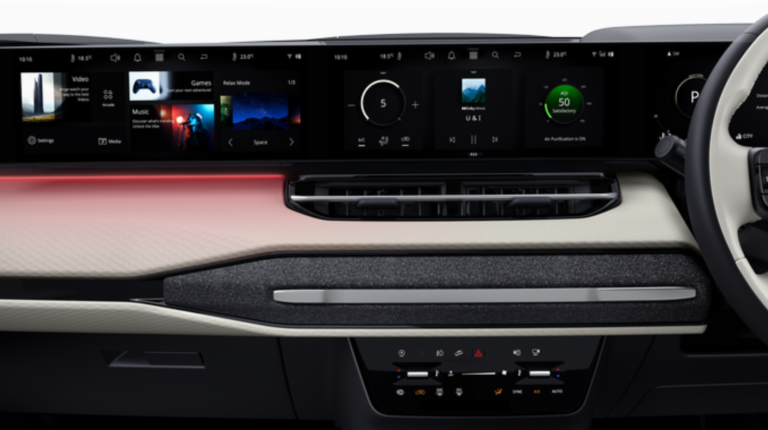 A close-up of a vehicle dashboard with Harman technologies.