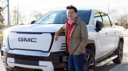 Stanley Fok in front of a GMC truck.