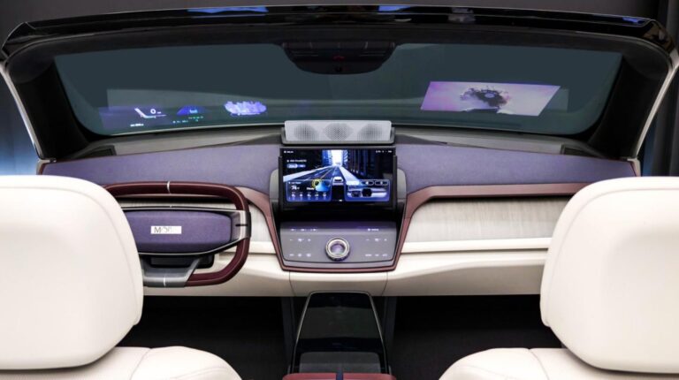 A transparent display integrated into the windshield above a display console and steering wheel.