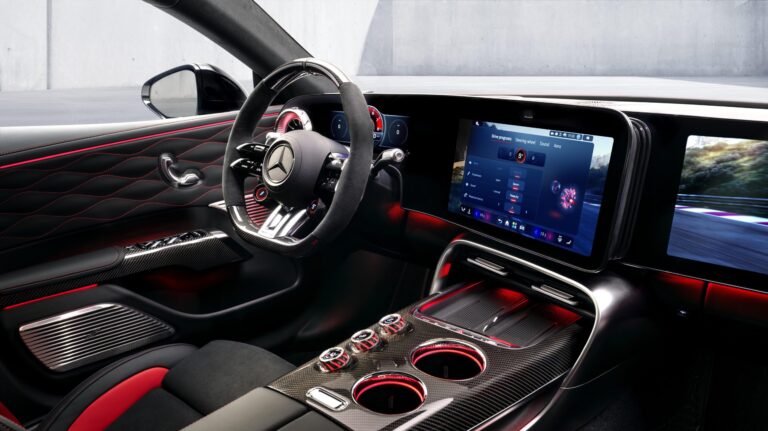 The interior of the new GT 4-Door Coupe, with a large touchscreen display, and red trim.