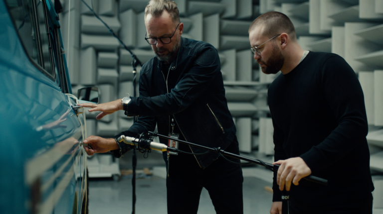 Scout Motors unveils Community UX audio design featuring engine recordings and acoustic guitars Two engineers record sounds on a Scout vehicle in an anechoic chamber.