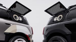 Two Mini Countryman concepts parked and facing each other, with their rear trunks open and speakers facing out.