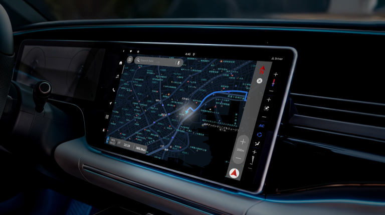 In-vehicle display of the Micware’s LeerosNavi navigation application running on the Sparq OS. The vehicle is dark and it is dark outside.
