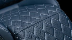 Close up of the sustainable automotive seating material from Magna, in a grey color with a zigzag pattern.