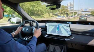 Dash of a BMW vehicle with BMW Maps displayed on the center console.