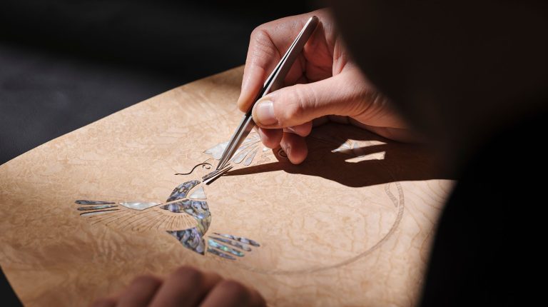 Rolls-Royce presents Phantom Hummingbird with abalone-shell interior marquetry A craftsperson shapes a piece of material by hand.