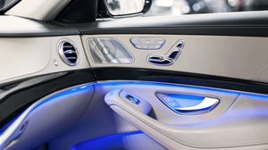 Interior of a vehicle, with light and dark grey on the center console, door and dashboard.