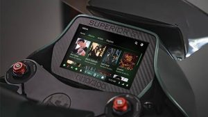 The dashboard screen on a Hush Cycles electric motorcyle, powered by Sparq OS. Visible are navigation and safety feature updates.
